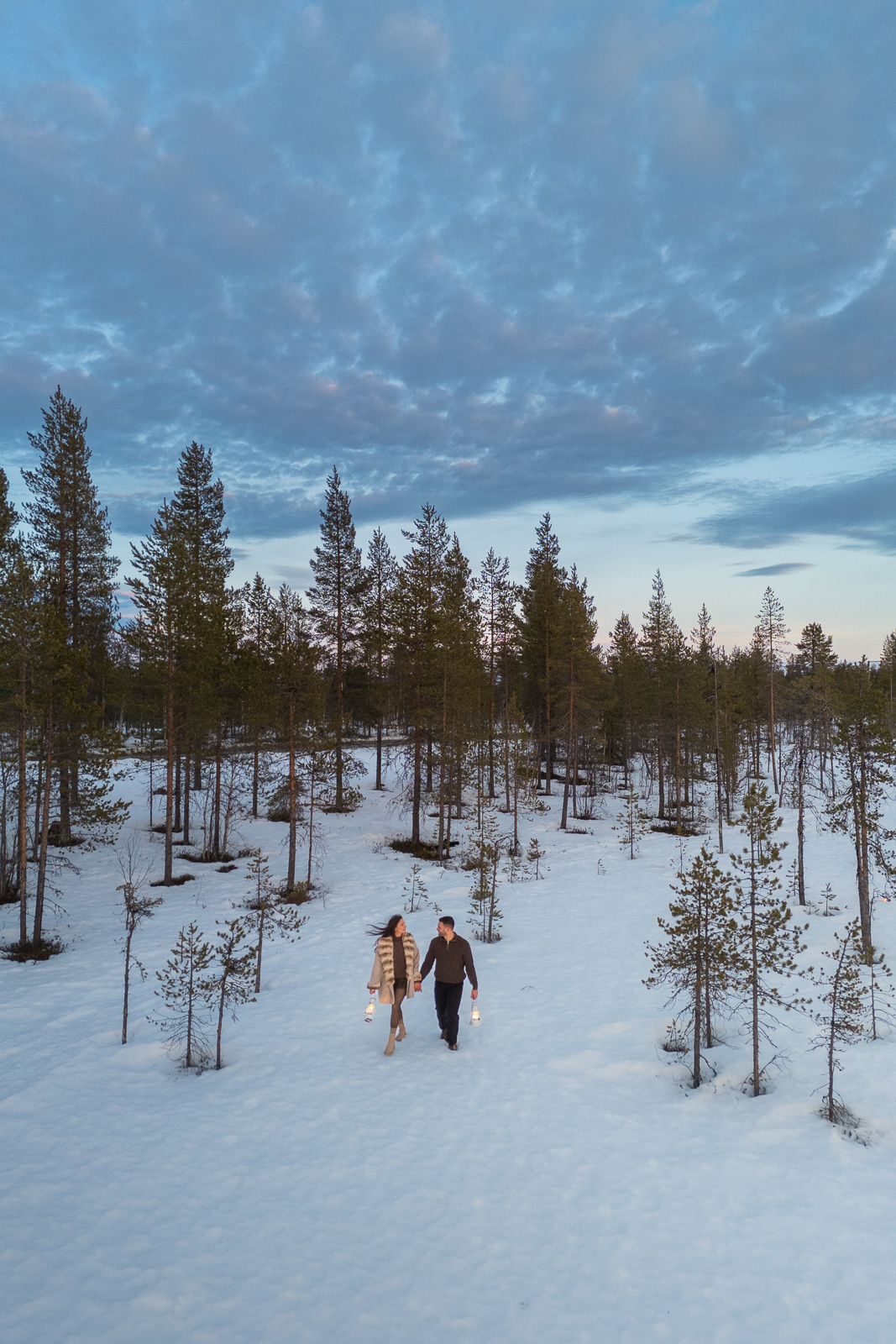 surprise proposal in Finnish Lapland at the end of winter during sunset