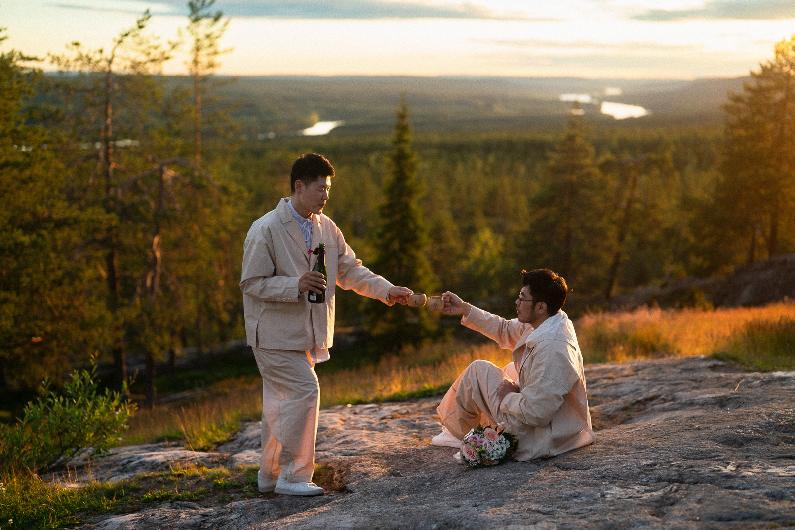 same sex couple drinking champange proposal photoshoot Rovaniemi