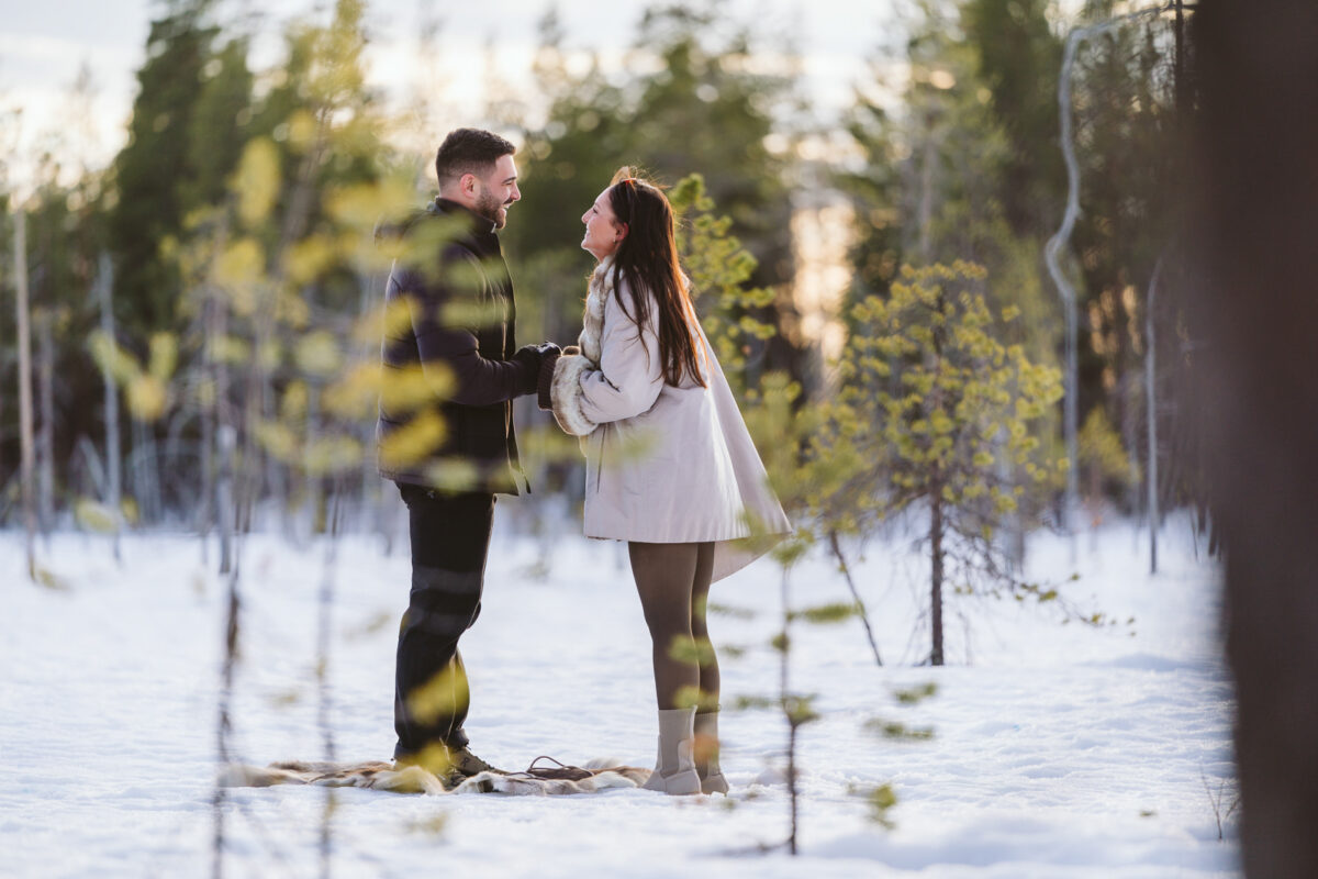 Sunset surprise proposal in Finnish Lapland in late winter